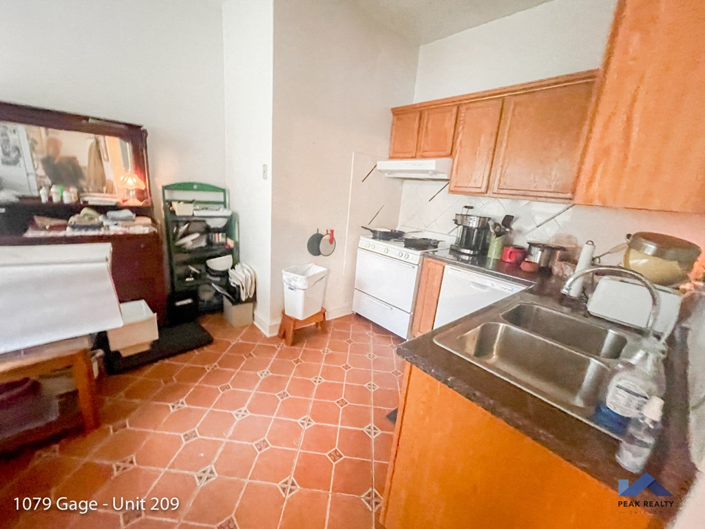 a kitchen with wooden cabinets and a sink