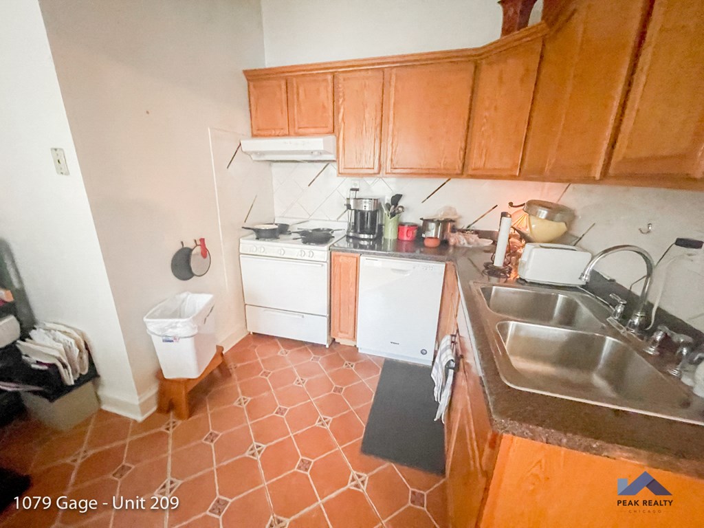 a kitchen with white appliances and wooden cabinets