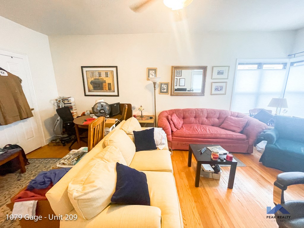 a living room with a red couch and a pink couch
