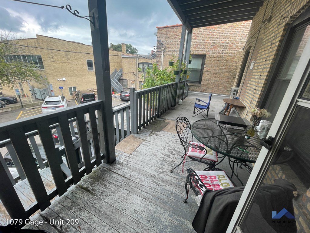 a balcony with a table and chairs and