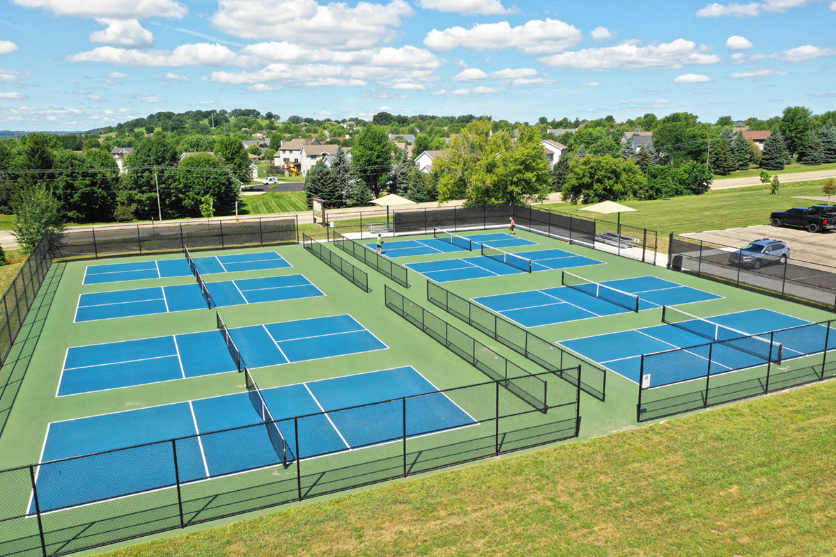 an aerial view of the tennis courts at the club
