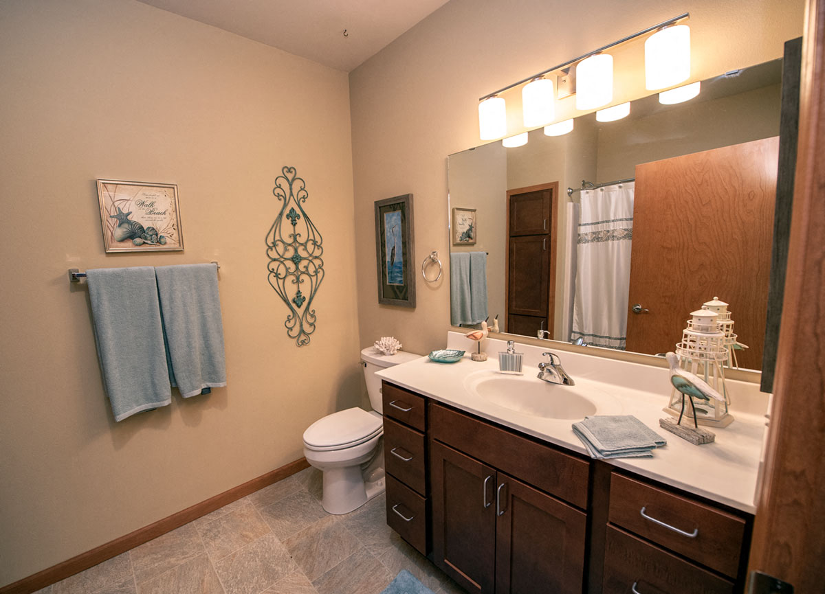 a bathroom with a sink and a toilet and a mirror