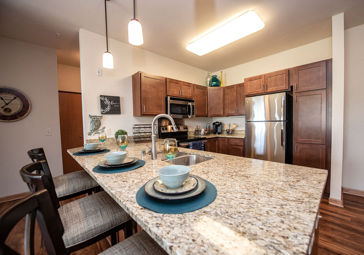 a kitchen with granite counter tops and stainless steel appliances