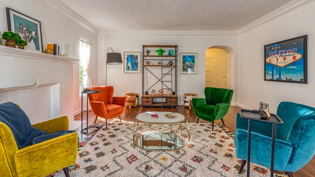 a living room with colorful furniture and a fireplace