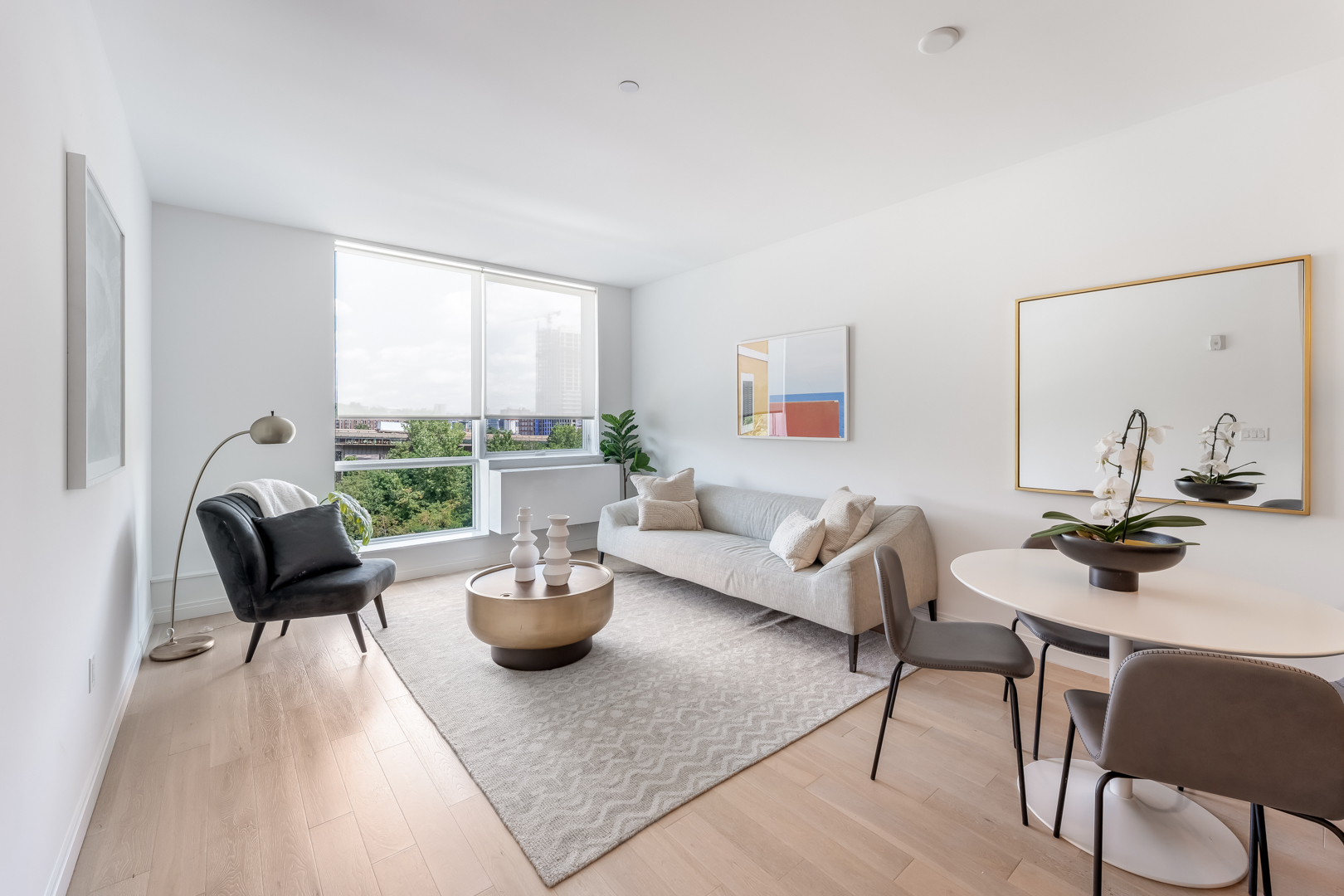 a living room with a couch and a table and a large window