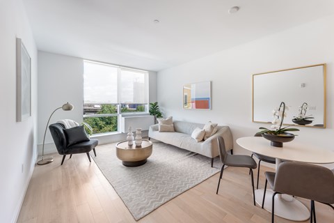 a living room with a couch and a table and a large window