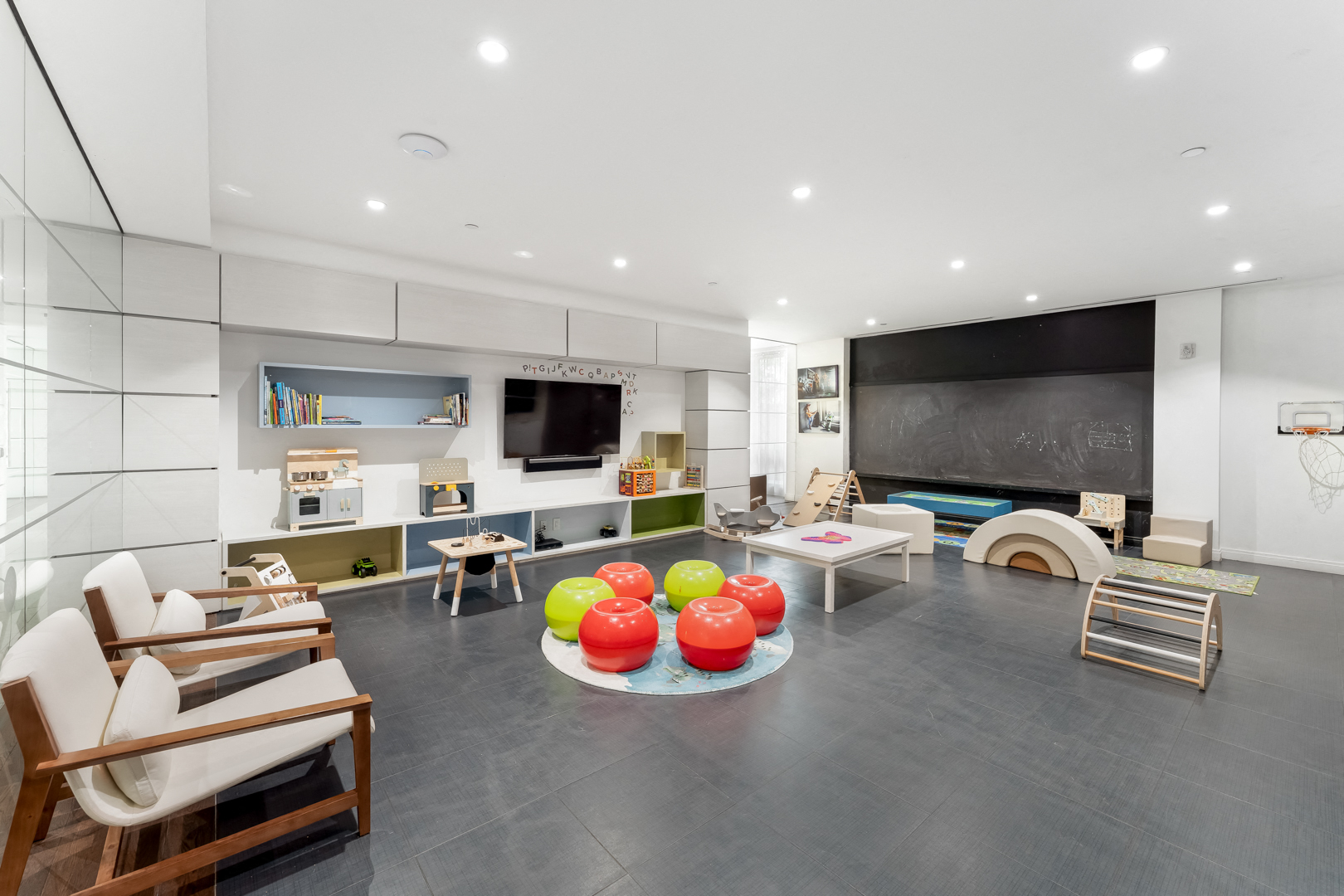 a living room filled with furniture and a large tv