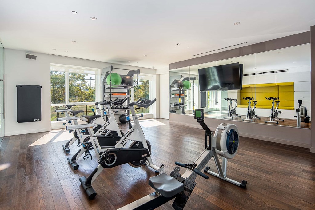 the gym has plenty of exercise equipment and a flat screen tv