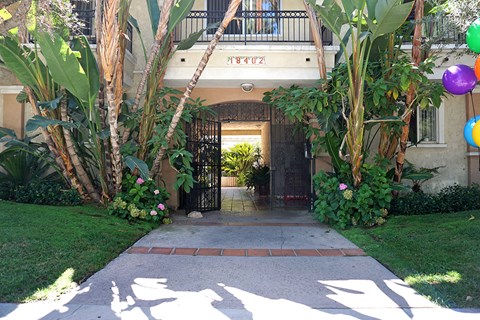 A gate with a metal railing and a house number 1402 above it.