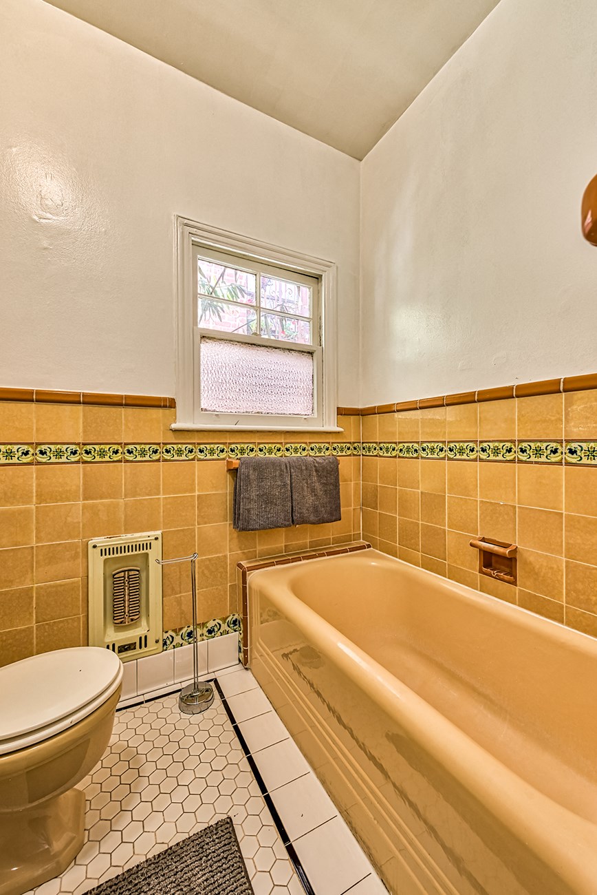 a bathroom with a toilet and a bath tub