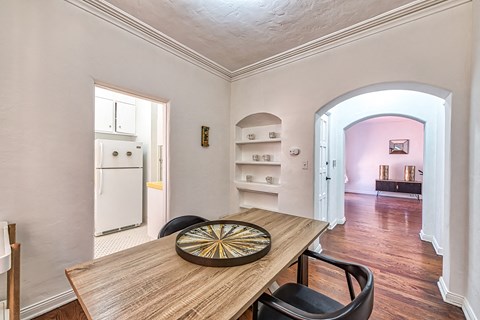 a dining room with a wooden table and black chairs