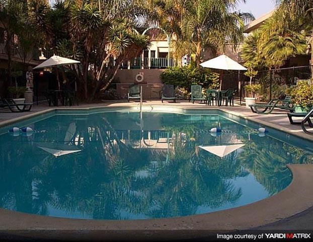 a swimming pool with umbrellas and chairs around it