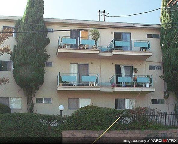 an apartment building with blue balconies and windows