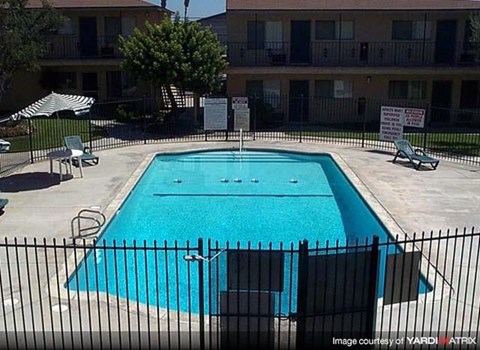 a swimming pool in front of an apartment building
