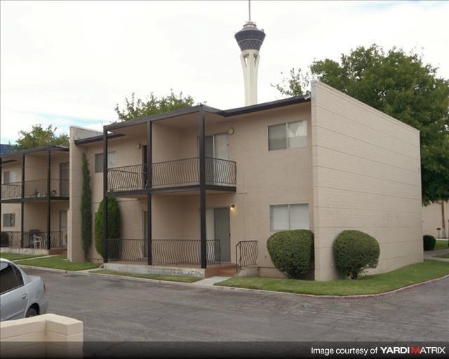an apartment building with a parking lot