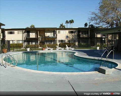 a swimming pool in front of an apartment building