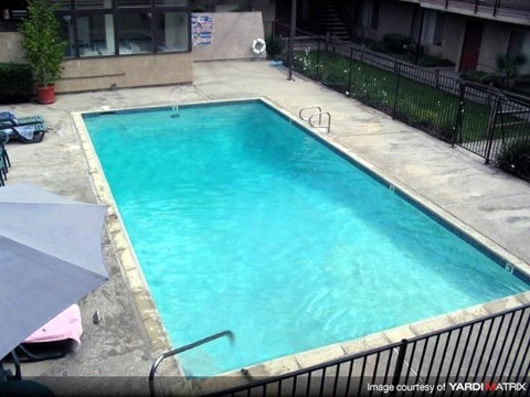 a large swimming pool in front of a building