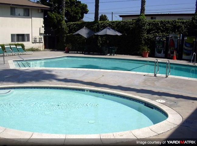 a swimming pool with an umbrella next to it