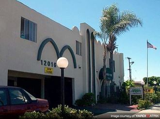 a building with a mcdonalds sign and a car parked in front