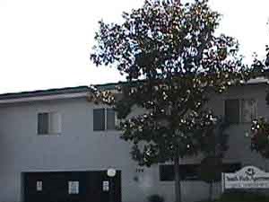 a white building with a sign on the side of a street