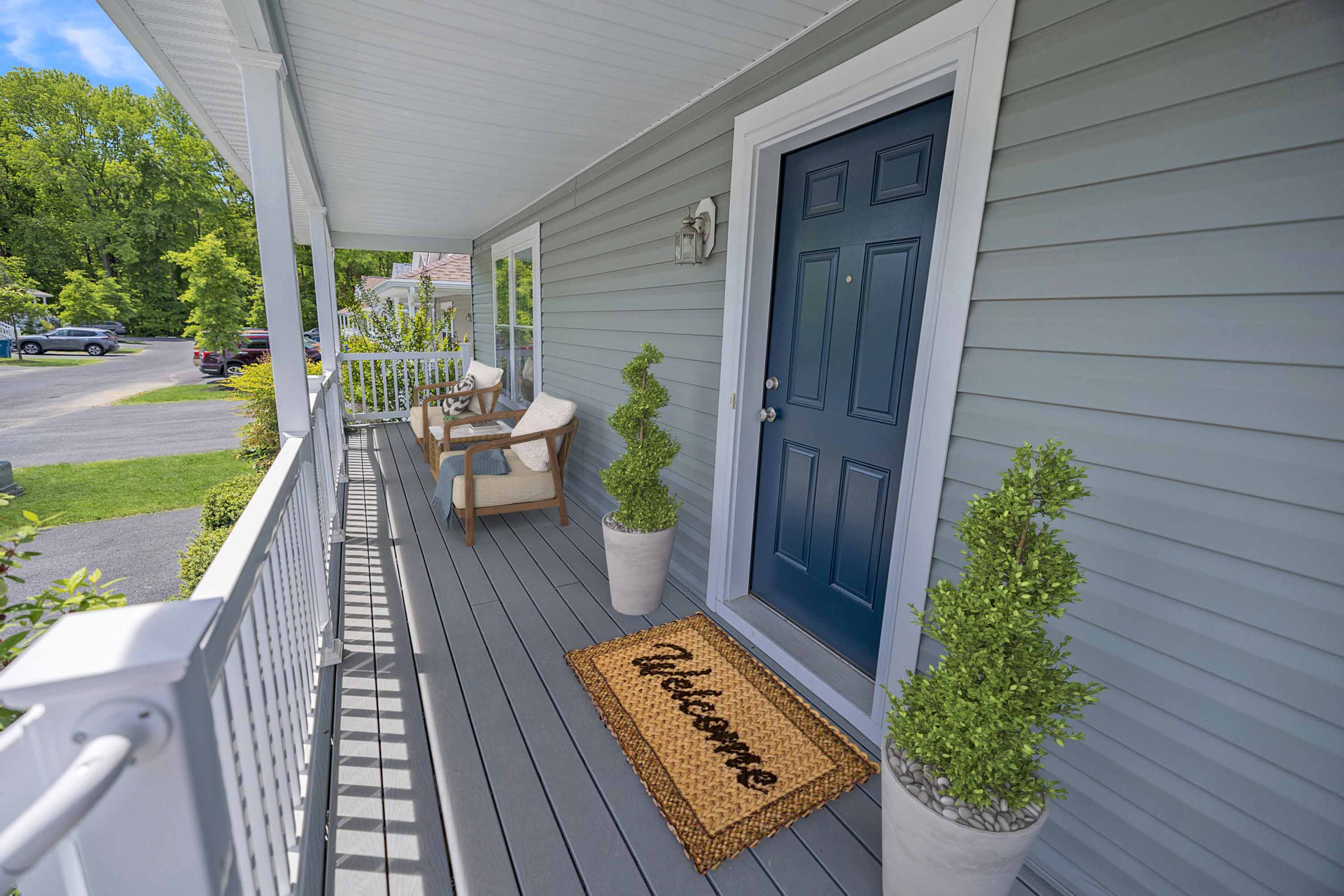 the front porch of a house with a blue door