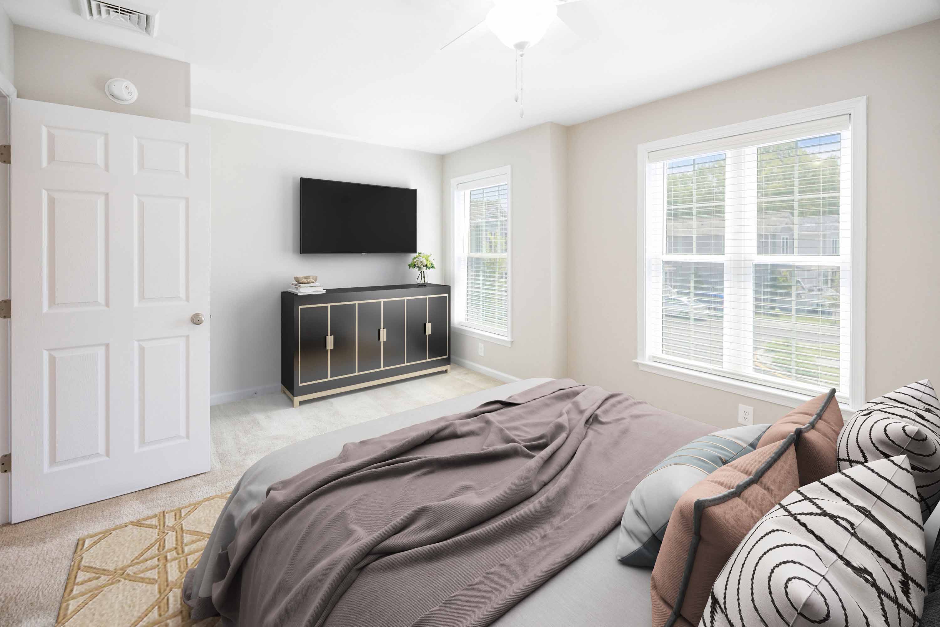 a bedroom with a bed and a tv