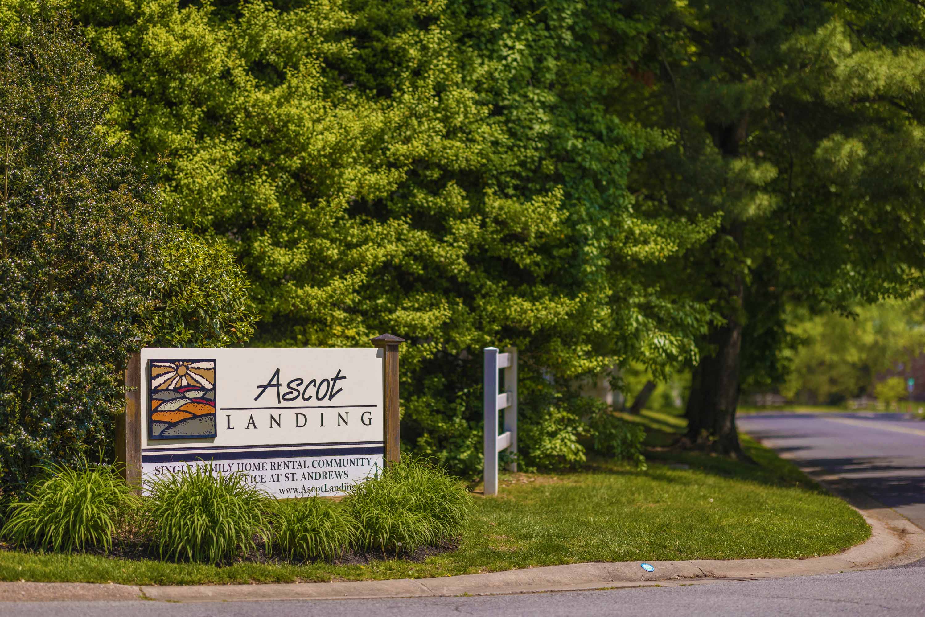 a sign for the act landing on the side of a road
