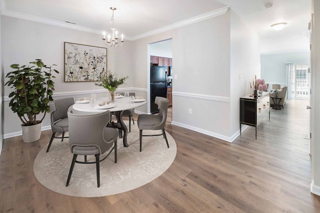 a dining room and living room with a table and chairs