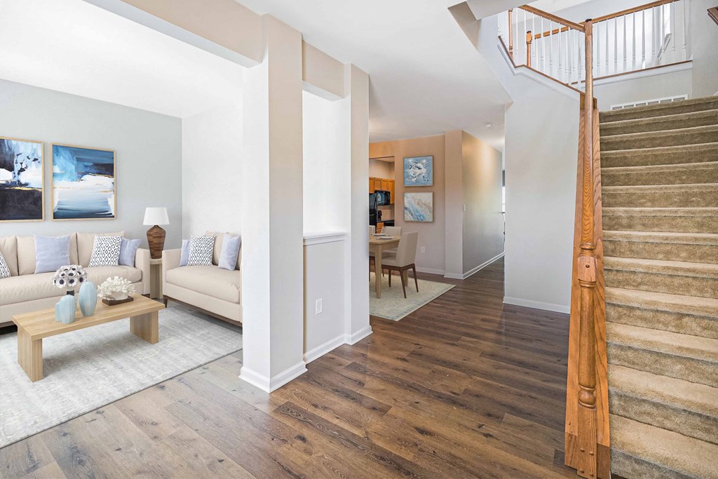 a living room with a staircase and a couch