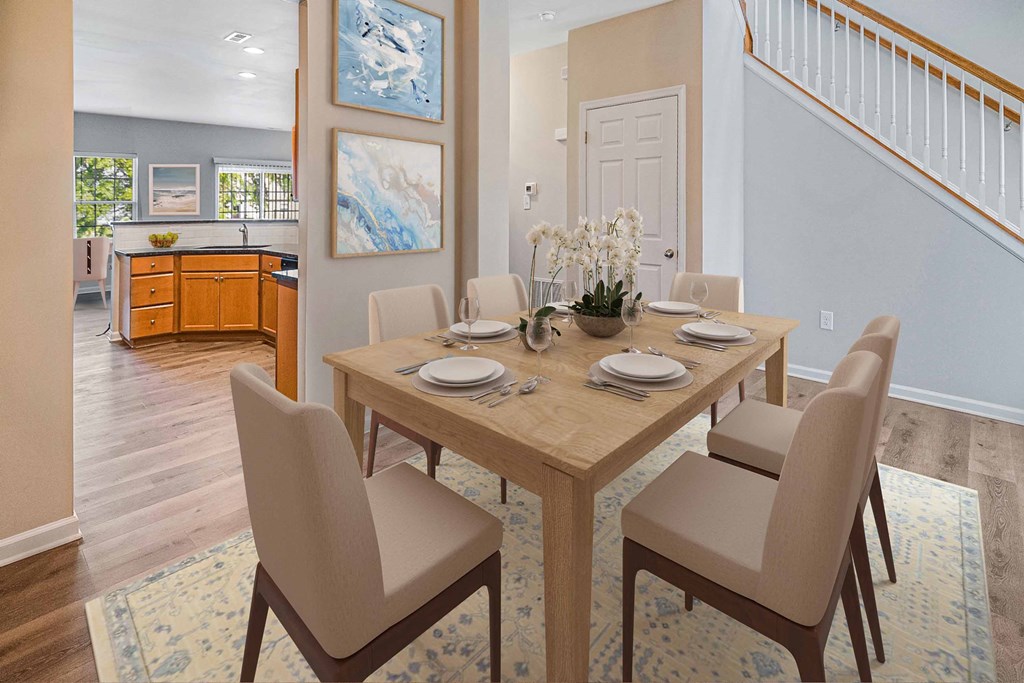 a dining room with a wooden table and chairs