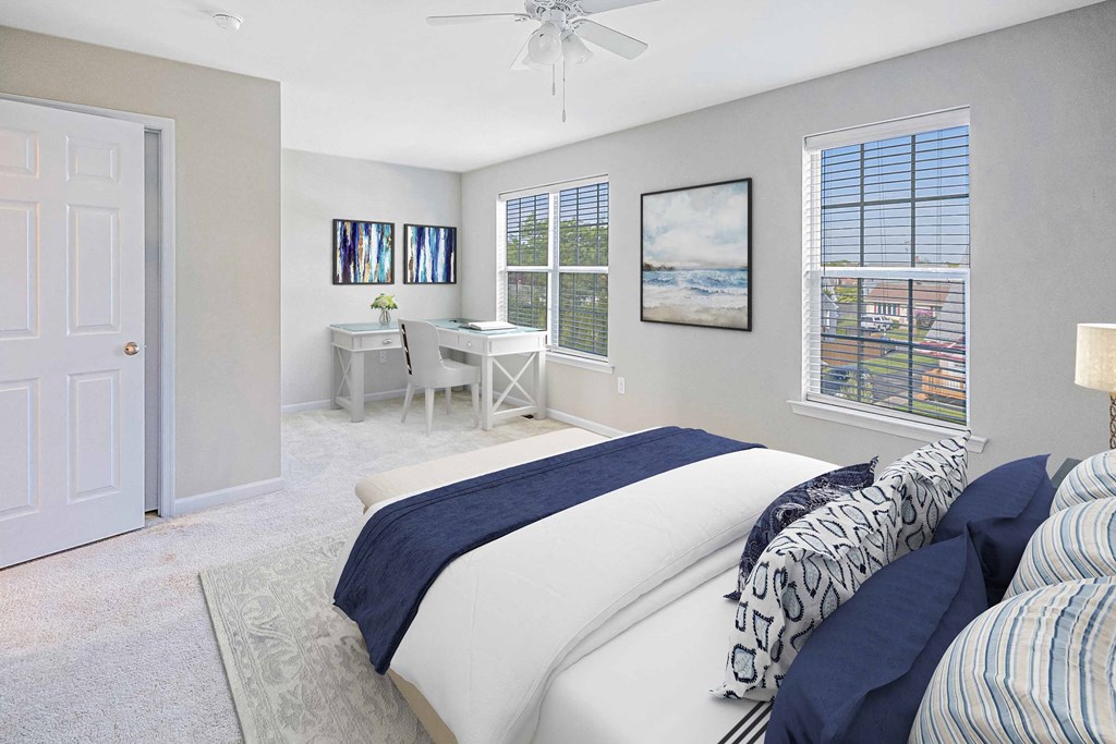 a bedroom with a bed and a desk