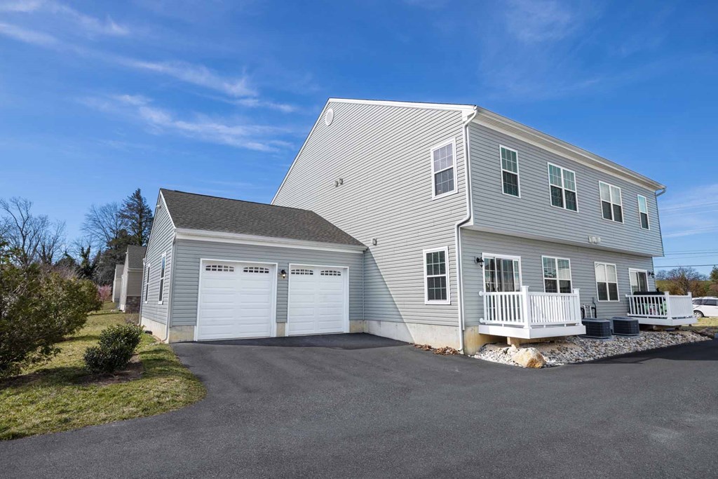 a white house with a garage and a driveway