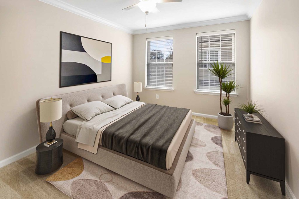 a bedroom with a bed and two windows