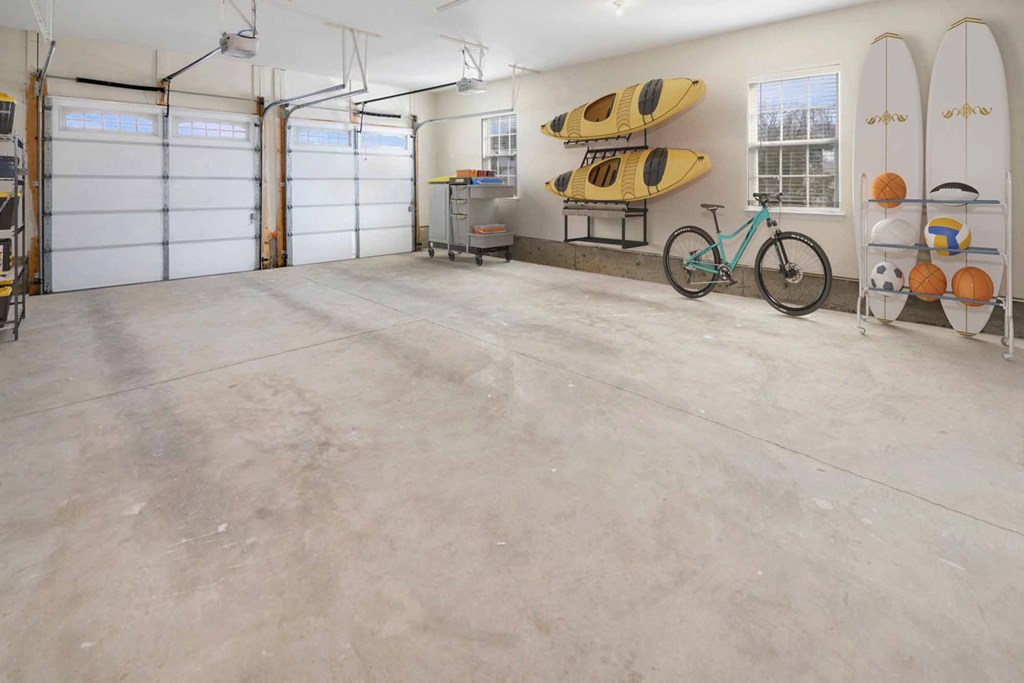 a garage with two garage doors and a bike in it