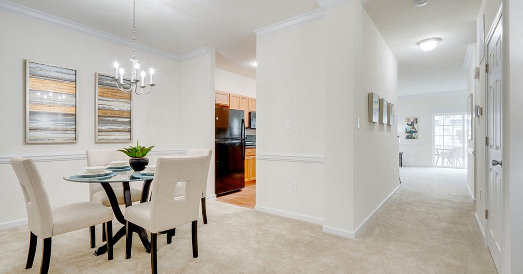 a dining room with a glass table and chairs