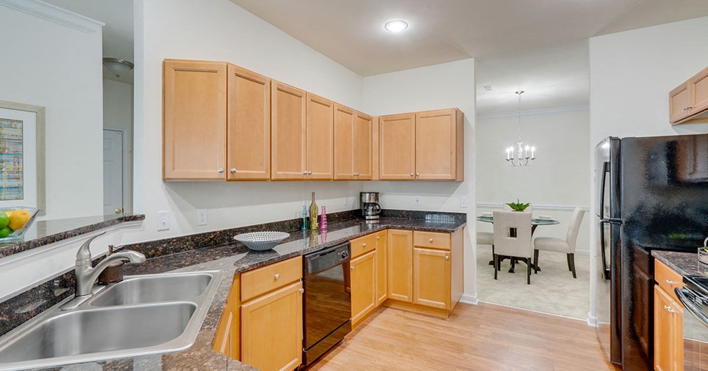 a kitchen with wooden cabinets and granite counter tops