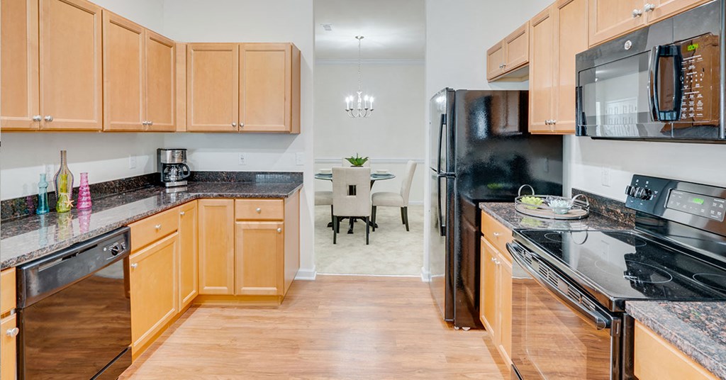 a kitchen with wooden cabinets and stainless steel appliances