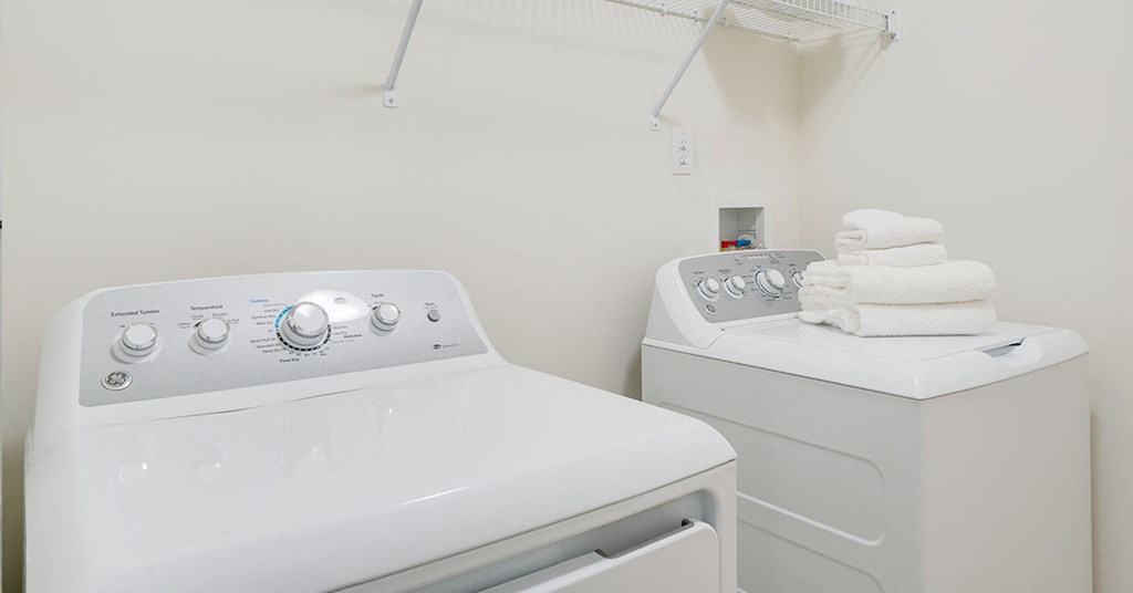 a washer and dryer in a white laundry room
