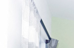 Model bedroom unit with carpeted floors and seating area