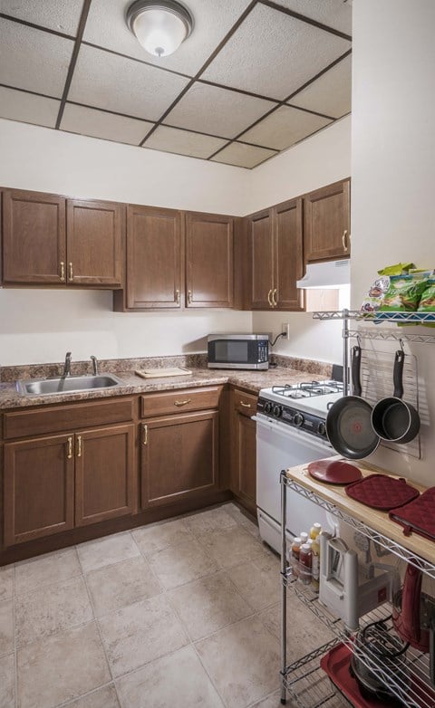 a kitchen with wooden cabinets and a stove and a sink