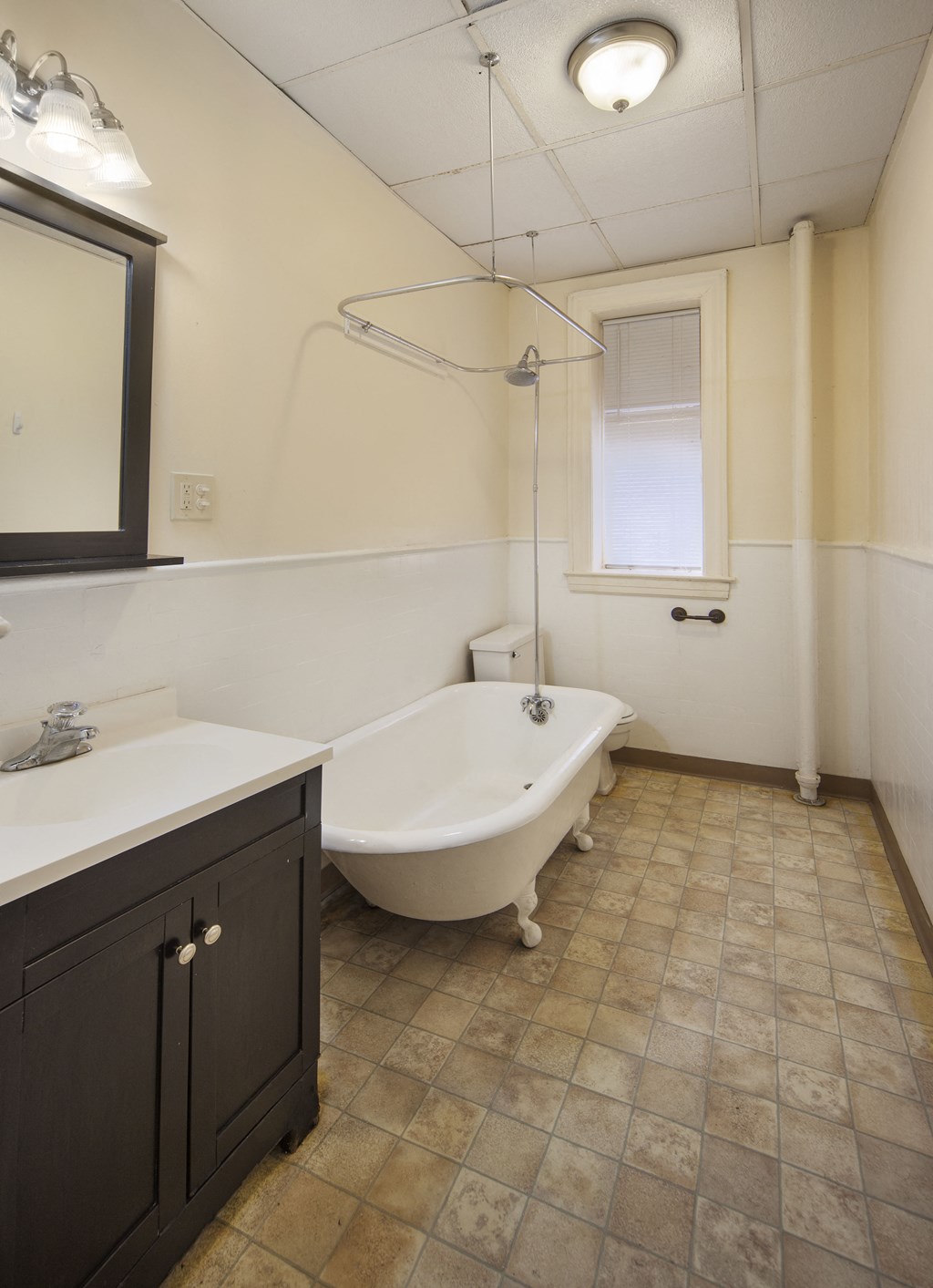 a bathroom with a tub and a sink and a mirror