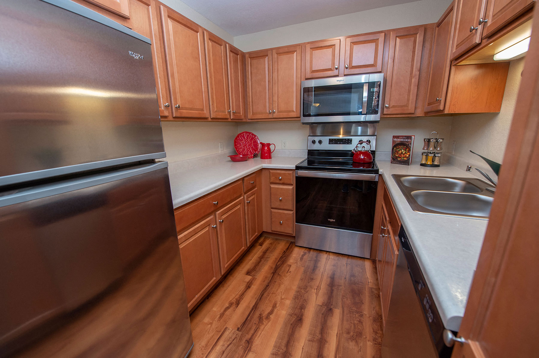 a kitchen with stainless steel appliances and wooden cabinets