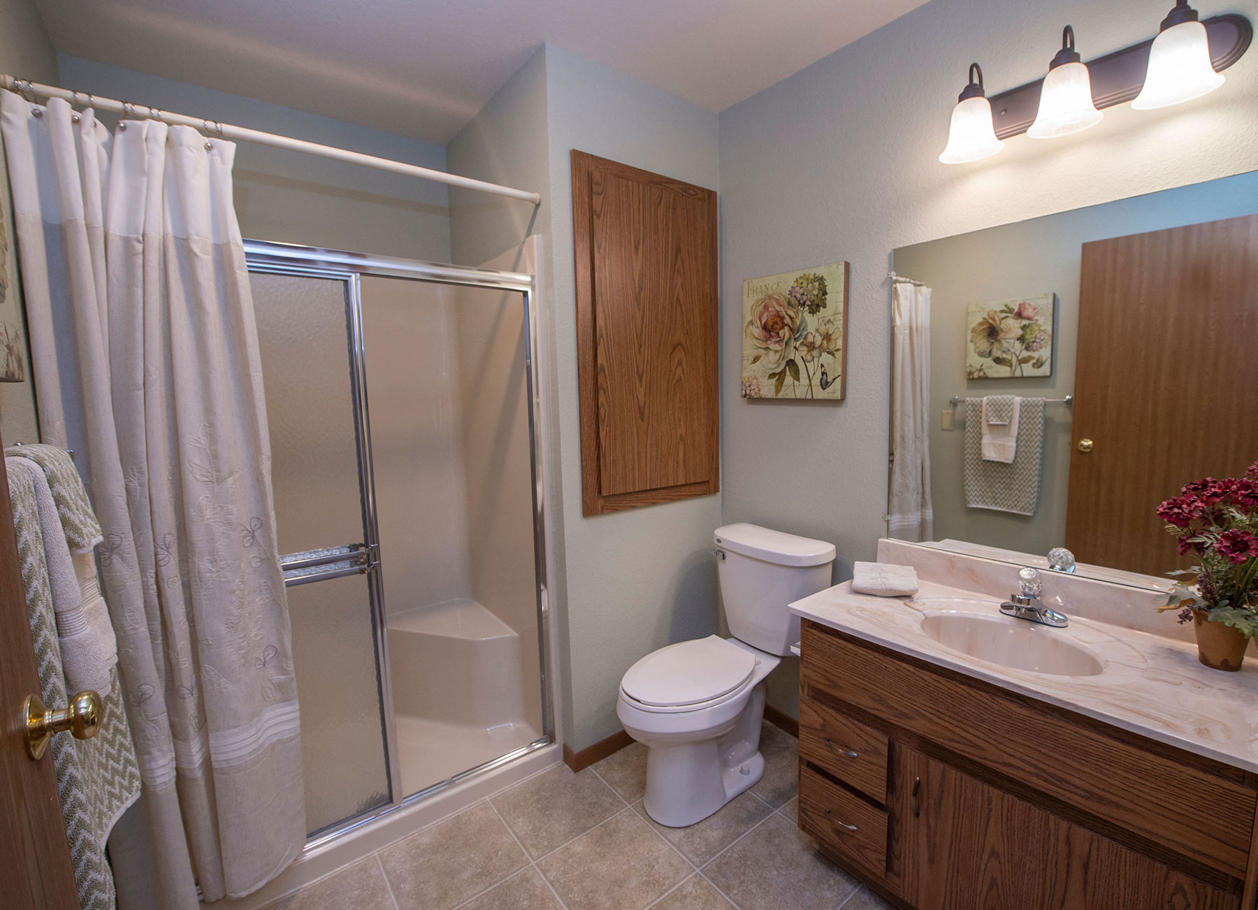 a bathroom with a shower toilet and sink