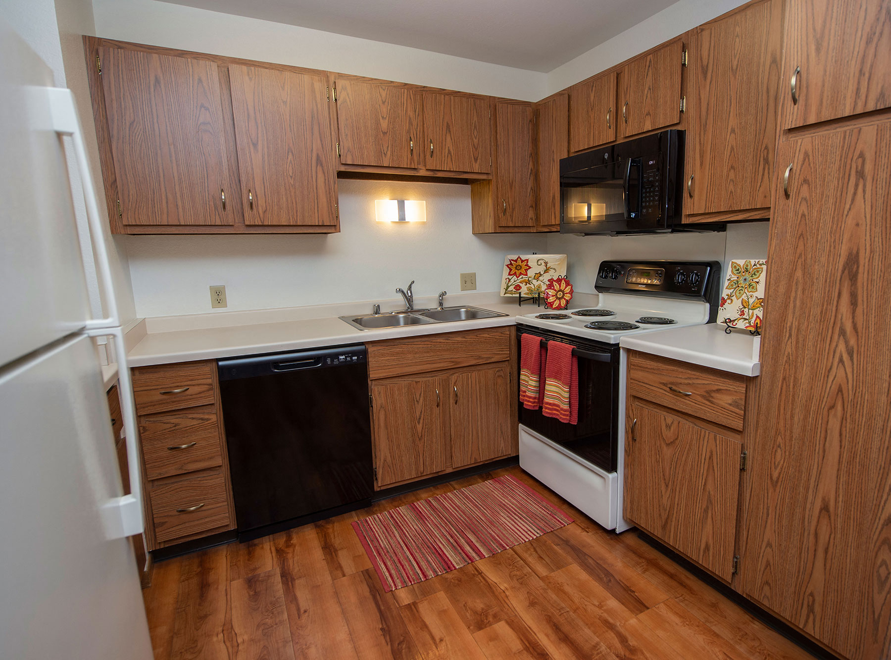 a kitchen with wooden cabinets and a stove and a sink