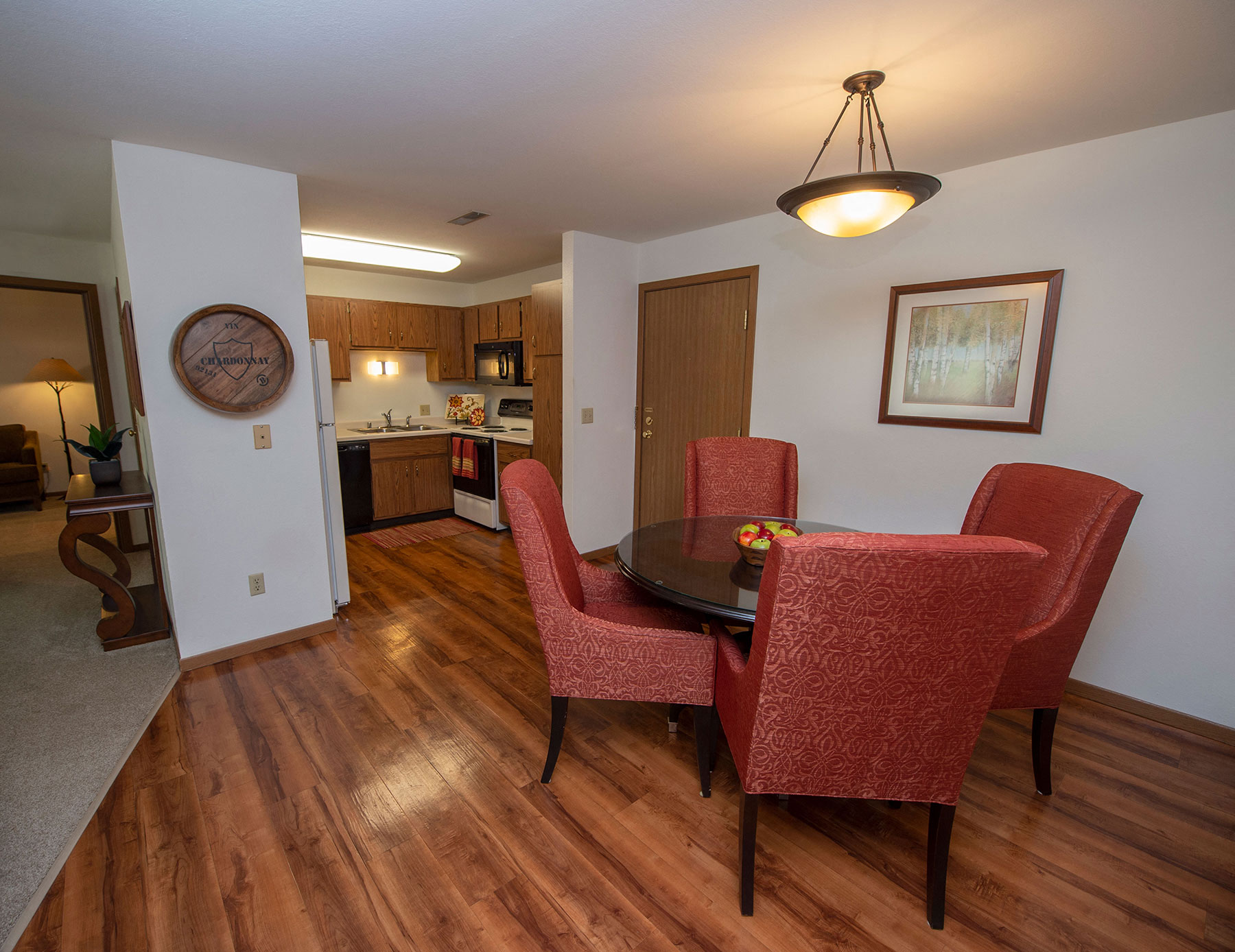 a dining room with a table and chairs and a kitchen