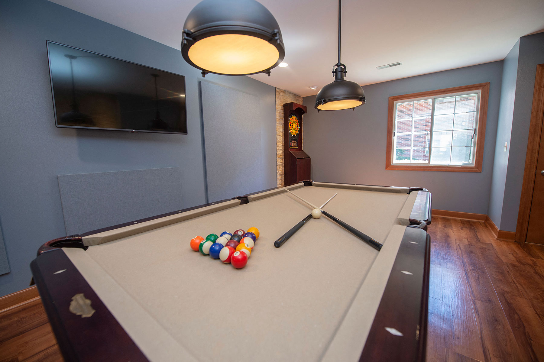 a pool table in a home with a tv