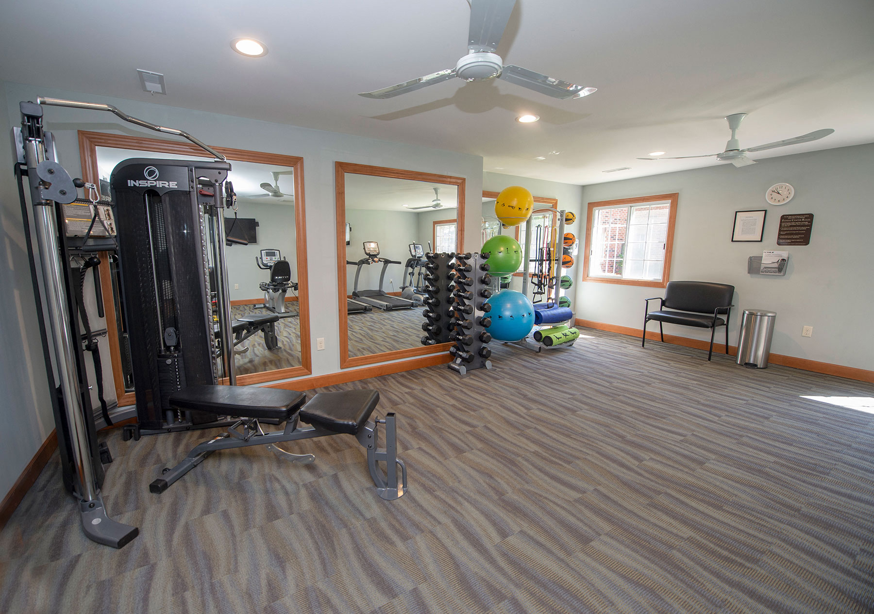 a home gym with a ceiling fan and exercise equipment