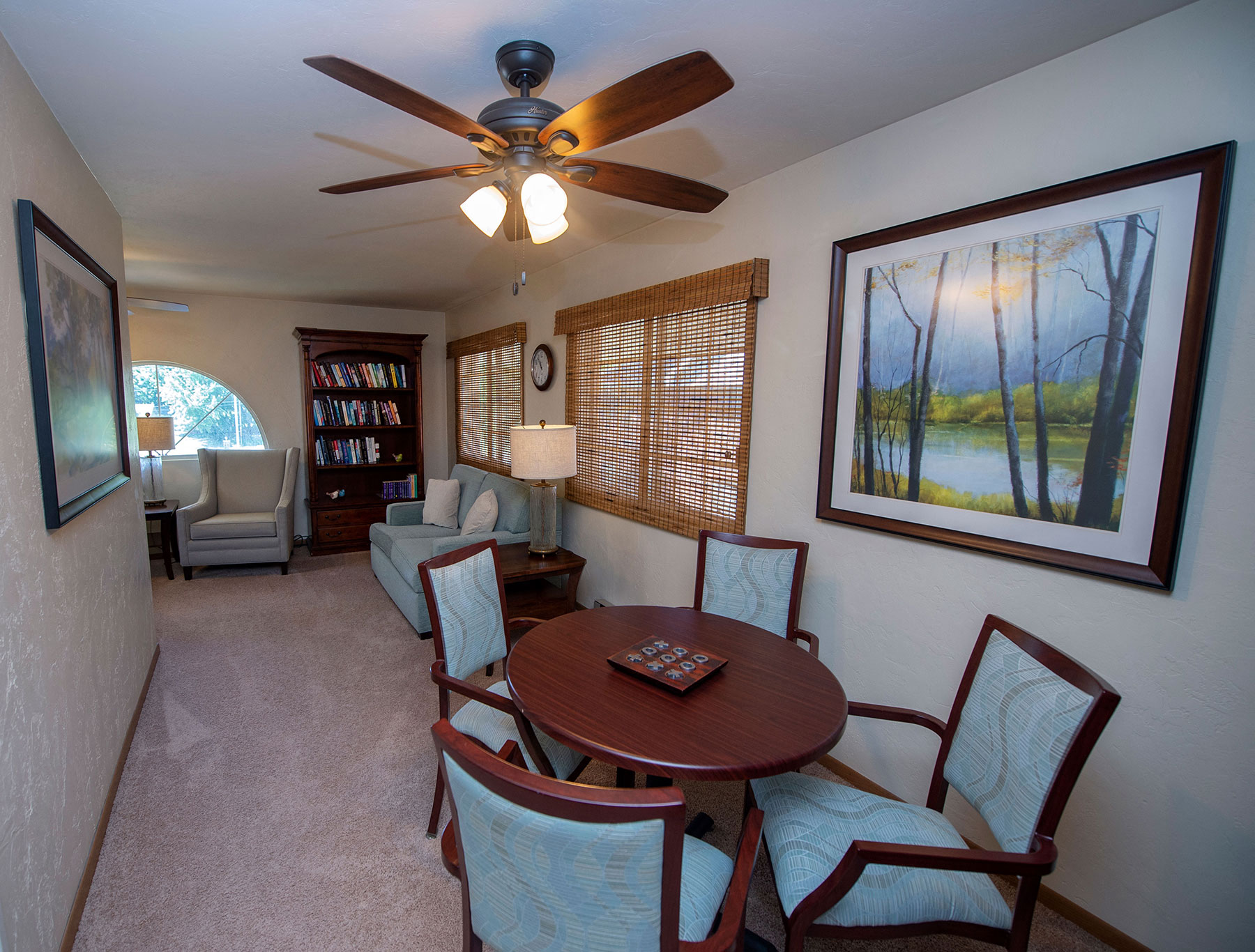 a dining room and living room with a table and chairs