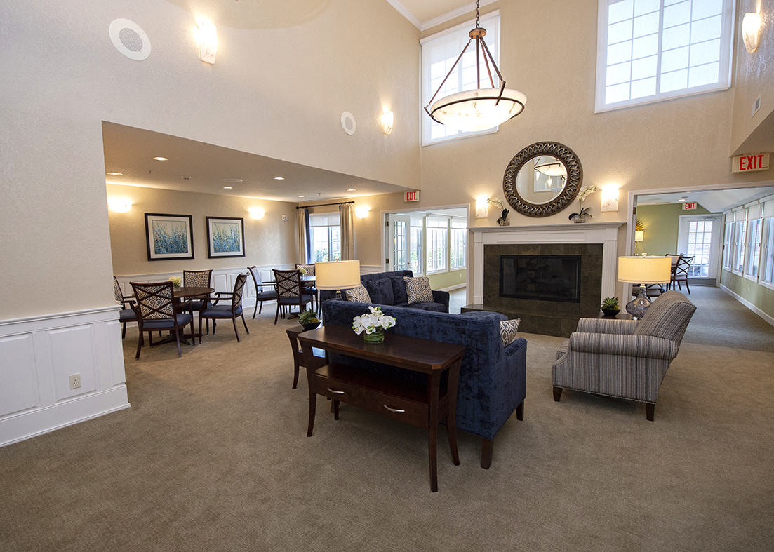 a large living room with a fireplace and a dining room