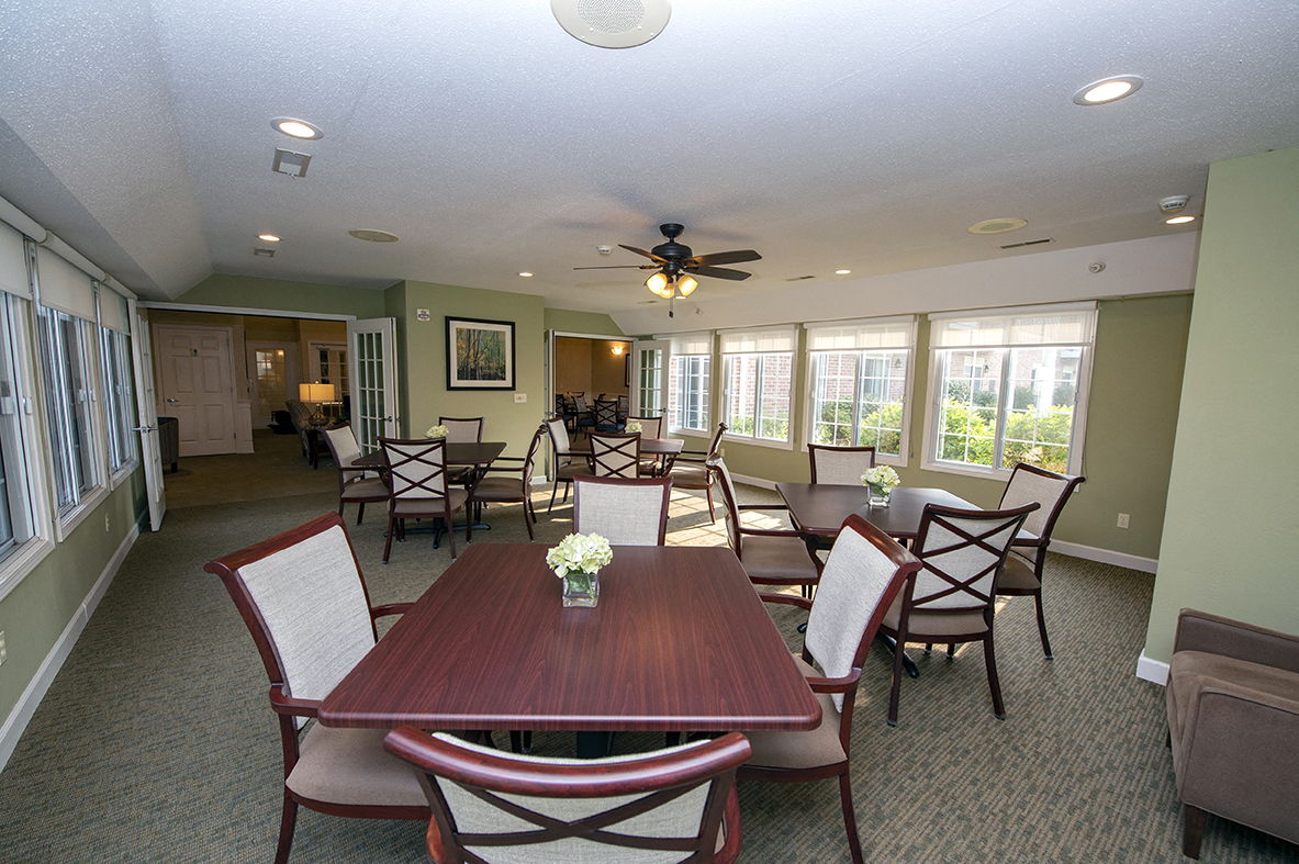 a dining room with a table and chairs and a ceiling fan